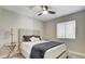 This bedroom has a neutral color palette, a ceiling fan, and natural lighting, creating a comfortable atmosphere at 2177 Hidden Ranch Ter, Henderson, NV 89052