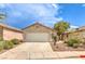 Cozy single-story home with a well-maintained front yard, attached garage, and a clean driveway under a sunny sky at 2177 Hidden Ranch Ter, Henderson, NV 89052
