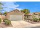 Charming single-story home with a well-manicured front yard, attached garage, and inviting driveway on a sunny day at 2177 Hidden Ranch Ter, Henderson, NV 89052
