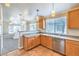Bright kitchen with stainless steel dishwasher, sink, and plenty of counter space, adjacent to the living area at 2177 Hidden Ranch Ter, Henderson, NV 89052