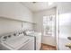 Laundry room including a window, shelf and a washer and dryer at 2177 Hidden Ranch Ter, Henderson, NV 89052