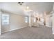 Spacious living room featuring neutral carpet, crown molding, and abundant natural light from multiple windows at 2177 Hidden Ranch Ter, Henderson, NV 89052