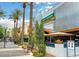 This vibrant restaurant features a lively outdoor patio, swaying palm trees, and ample bench seating along the walkway at 2177 Hidden Ranch Ter, Henderson, NV 89052