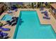 Aerial view of the sparkling community pool with lounge chairs and tables at 23 Hudson Canyon St # 3, Henderson, NV 89012