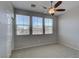 Bedroom featuring a ceiling fan, three windows and a closet at 23 Hudson Canyon St # 3, Henderson, NV 89012
