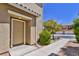 Close-up of the front door of a townhouse, complemented by a landscaped walkway and greenery at 23 Hudson Canyon St # 3, Henderson, NV 89012