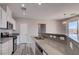 Open kitchen design boasts stainless appliances, gray counters, and ample counter seating, perfect for casual dining at 23 Hudson Canyon St # 3, Henderson, NV 89012