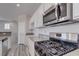 Modern kitchen features stainless steel appliances, sleek countertops, and white cabinets with plenty of space for storage at 23 Hudson Canyon St # 3, Henderson, NV 89012