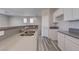 Open concept kitchen with stainless steel sink, gray countertops, and white cabinets, perfect for modern living at 23 Hudson Canyon St # 3, Henderson, NV 89012