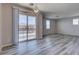 Bright living room with wood-look floors, large windows, and modern lighting, ready for your personal touch at 23 Hudson Canyon St # 3, Henderson, NV 89012