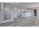 Open living space featuring gray wood floors, recessed lights, a kitchen, and in-unit washer and dryer at 23 Hudson Canyon St # 3, Henderson, NV 89012