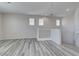 Spacious loft area with modern gray wood floors, neutral walls, recessed lighting, and natural light at 23 Hudson Canyon St # 3, Henderson, NV 89012