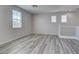 Loft featuring sleek gray wood floors, neutral walls, large windows, and modern recessed lighting at 23 Hudson Canyon St # 3, Henderson, NV 89012