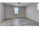 Spacious loft with modern gray wood floors, neutral paint, and ample natural light from strategically placed windows at 23 Hudson Canyon St # 3, Henderson, NV 89012