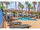 Relaxing community pool area with comfortable lounge chairs and lush tropical landscaping at 2725 S Nellis Blvd # 2168, Las Vegas, NV 89121