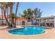 Community pool area featuring palm trees and lounge chairs at 2725 S Nellis Blvd # 2168, Las Vegas, NV 89121