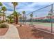 A community tennis court framed by lush palm trees in a residential area at 2725 S Nellis Blvd # 2168, Las Vegas, NV 89121
