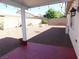 Spacious backyard featuring desert landscaping and a covered patio with string lights at 2905 Shimmering Bay St, Laughlin, NV 89029
