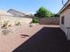 Expansive backyard featuring desert landscaping, a brick retaining wall and privacy fence at 2905 Shimmering Bay St, Laughlin, NV 89029