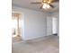 Bedroom featuring neutral paint, a ceiling fan, two doors, and plush carpeting at 2905 Shimmering Bay St, Laughlin, NV 89029