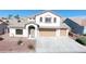 Charming two-story home featuring a well-maintained front yard and attached two-car garage at 2905 Shimmering Bay St, Laughlin, NV 89029
