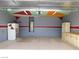 View of the garage featuring painted ceiling and walls, epoxy flooring, and built-in cabinets for storage at 2905 Shimmering Bay St, Laughlin, NV 89029