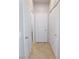 Neutral hallway featuring tile floors, closet, and doors at 2905 Shimmering Bay St, Laughlin, NV 89029
