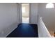 Upstairs hallway with blue carpet leading to carpeted bedrooms, and natural light from an arch window at 2905 Shimmering Bay St, Laughlin, NV 89029
