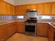 Kitchen with wood cabinets, stainless steel appliances, and tile flooring at 2905 Shimmering Bay St, Laughlin, NV 89029