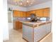Kitchen featuring wood cabinets, tile backsplash, and breakfast bar at 2905 Shimmering Bay St, Laughlin, NV 89029