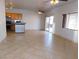 Open-concept living area with tile flooring, kitchen access, and patio doors at 2905 Shimmering Bay St, Laughlin, NV 89029