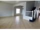 Spacious living room with neutral paint, tile floors, arched doorway, and staircase at 2905 Shimmering Bay St, Laughlin, NV 89029
