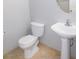 Picture of a powder room featuring a white toilet and pedestal sink at 2905 Shimmering Bay St, Laughlin, NV 89029