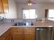 Kitchen sink featuring wood cabinets, stainless appliances, and open floorplan at 2905 Shimmering Bay St, Laughlin, NV 89029