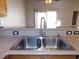 Kitchen sink featuring wood cabinets, stainless appliances, and open floorplan at 2905 Shimmering Bay St, Laughlin, NV 89029