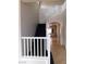 Interior view of staircase featuring neutral paint, white railing, and black carpet at 2905 Shimmering Bay St, Laughlin, NV 89029