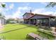 A large backyard with artificial turf and outdoor seating, perfect for entertaining or enjoying the outdoor at 3400 Sioux Way, Las Vegas, NV 89169