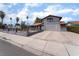 Inviting gray two-story home featuring a well-kept yard, decorative fence and mature palms at 3400 Sioux Way, Las Vegas, NV 89169