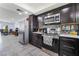 Kitchen with dark stained wood cabinetry and stainless steel appliances at 3400 Sioux Way, Las Vegas, NV 89169