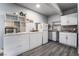Basement kitchenette area with white cabinets, shelving, and a mini fridge at 3400 Sioux Way, Las Vegas, NV 89169