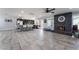 Spacious, open concept, living room with fireplace, kitchen, ceiling fan and ceramic tile at 3400 Sioux Way, Las Vegas, NV 89169