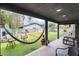 Cozy covered patio features comfortable seating, tile floors, and a tranquil view of the lush backyard at 3400 Sioux Way, Las Vegas, NV 89169
