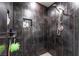 Modern shower with dark gray tile, built-in niche, and brushed nickel shower head at 3400 Sioux Way, Las Vegas, NV 89169