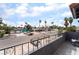 Balcony view shows a street with palm trees, single story houses, and a view of Las Vegas in the distance at 3400 Sioux Way, Las Vegas, NV 89169