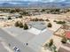 An aerial view of a charming home featuring desert landscaping, a spacious driveway and a two-car garage at 3451 Sagebrush Ave, Pahrump, NV 89048