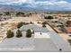 A high angle aerial view of a desert home with desert landscaping and an oversized lot with ample space and mountain views at 3451 Sagebrush Ave, Pahrump, NV 89048