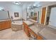 Large bathroom with a tub, tile floors, double sinks, and wood cabinets providing lots of storage space at 3451 Sagebrush Ave, Pahrump, NV 89048