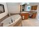 Relax in this bathroom with a deep soaking tub, a single vanity, and decorative accents at 3451 Sagebrush Ave, Pahrump, NV 89048