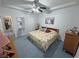 Bedroom with a ceiling fan, patterned bedspread, and built-in ironing board with storage cabinet at 3451 Sagebrush Ave, Pahrump, NV 89048