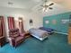This roomy bedroom has two beds, a ceiling fan, and comfortable places to sit and relax at 3451 Sagebrush Ave, Pahrump, NV 89048